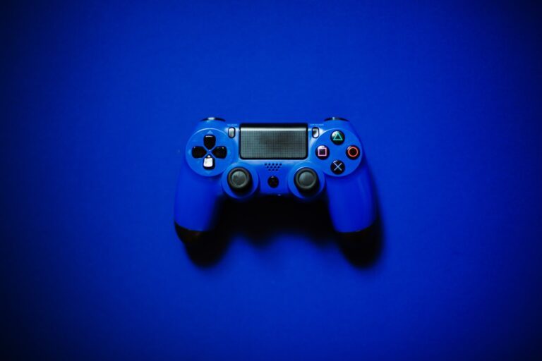 A blue game controller on a dark blue background